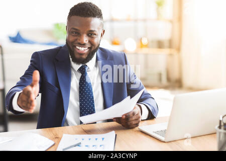African american young businessman extending hand to shake Stock Photo