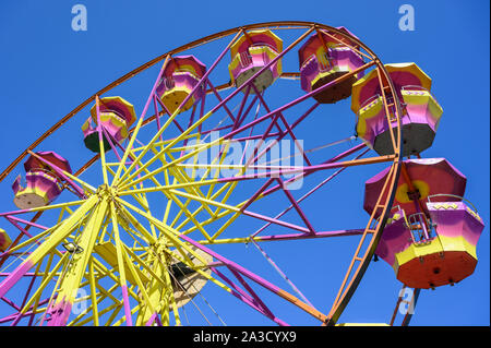 An old, brightly painted, ferris wheel at a travelling fairground in Messini,Peloponnese, Greece. Stock Photo