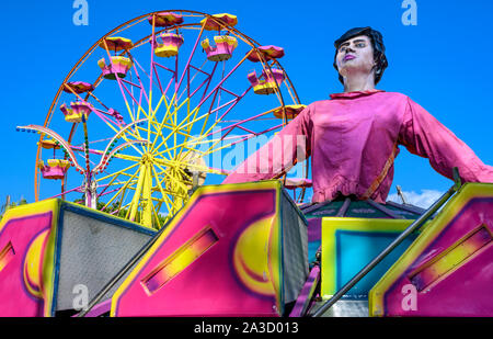 Brightly painted, fairground rides at a travelling fairground in Messini,Peloponnese, Greece. Stock Photo