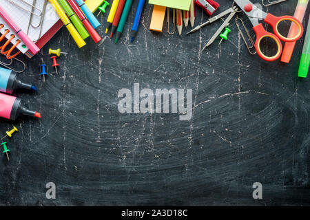 Border of School supplies on a chalkboard background. Free space Stock Photo