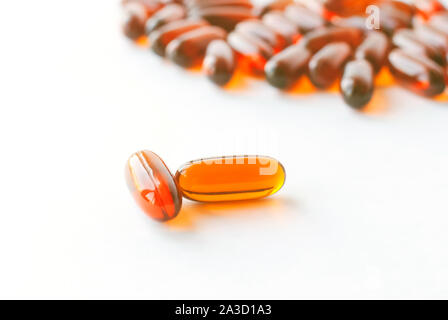 Few lecithins capsules isolated on the white background. Natural pills Stock Photo
