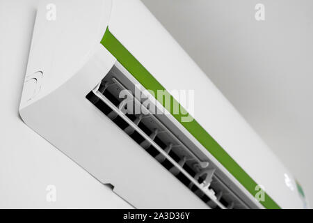 Air conditioner mounted on a white wall in the living room or bedroom. Indooor comfort temperature. Health concepts and energy savings. Stock Photo