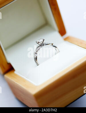 Diamond engagement ring in it's wooden display box Stock Photo