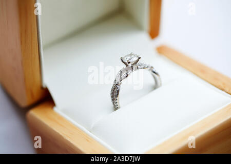 Diamond engagement ring in it's wooden display box Stock Photo