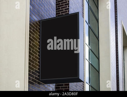 Blank black outdoor box mock up on brick wall mounted Stock Photo