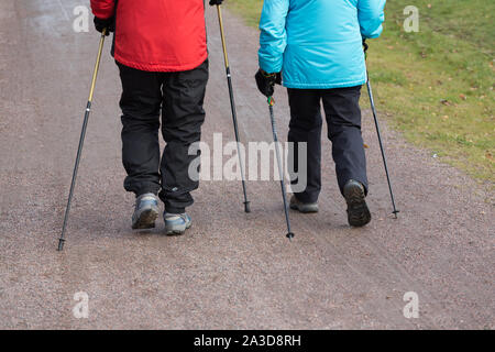 Elderly couple doing daily excercise by nordic walking Stock Photo
