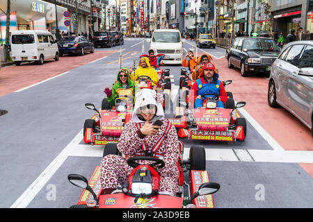 Tokyo, Shibuya crossing. Go karting Mario Karts with Caucasians dressed ...