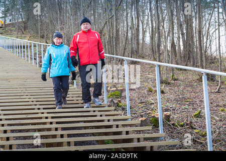 Elderly couple doing daily excercise by walking stairs Stock Photo
