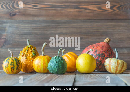 Assortment of ornamental pumpkins on the wooden background Stock Photo