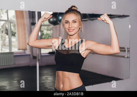 Attractive blonde woman at gym resting after workout and smiling Stock  Photo - Alamy