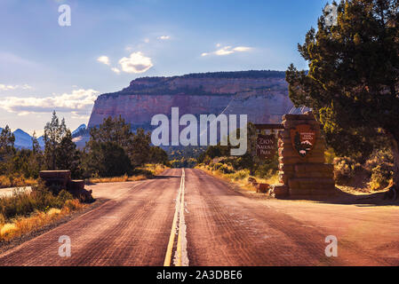 Road and welcome sign at the entrance to Zion National Park before sunset Stock Photo