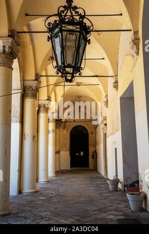 Arched colonnade in courtyard of Palazzo del Governo (Government Palace) in old Celestine Convent in Lecce, Apulia (Puglia), Southern Italy Stock Photo