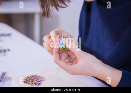Designer making handmade brooch Stock Photo