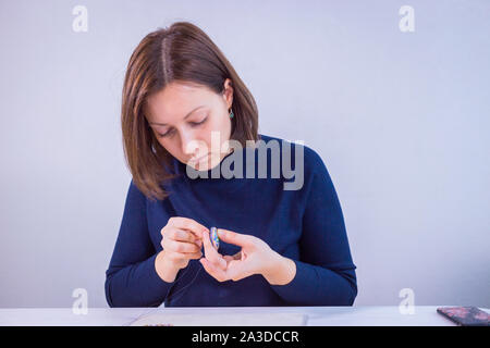 Designer making handmade brooch Stock Photo