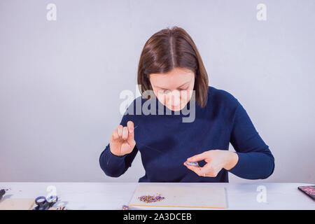 Designer making handmade brooch Stock Photo