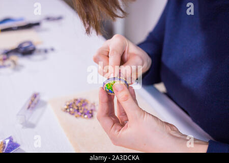 Designer making handmade brooch Stock Photo