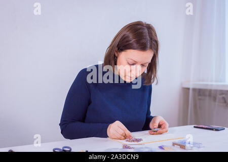 Designer making handmade brooch Stock Photo