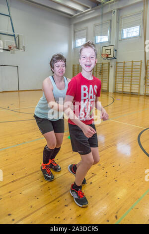 Group of disabled down syndrome men and women doing sports at indoor gym Stock Photo