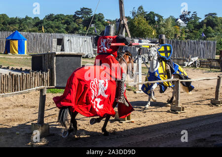 Medieval knights in suit of armour on horseback during jousting tournament at the Château de Tiffauges, Vendée, France Stock Photo