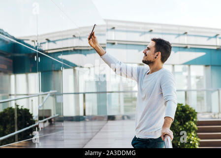 Smiling young bearded man a selfie in the city at Spain- Barcelona Stock Photo