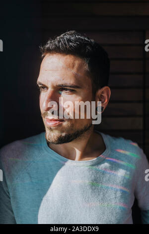 Handsome hispanic man at home looking to side, relax profile pose Stock Photo