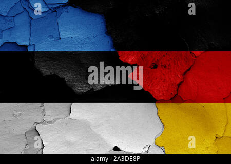 flags of Estonia and Germany painted on cracked wall Stock Photo