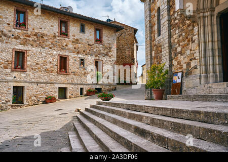 Ancient stone gray stairs and masonry buildings on narrow alley in town in Italy Stock Photo