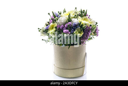 Bouquet of flowers in a round gift box on a white background. Great Gift for Wedding, Birthday, Valentine's Day or Mother's Day. Copy space Stock Photo