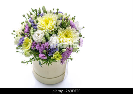 Bouquet of flowers in a round gift box on a white background. Great Gift for Wedding, Birthday, Valentine's Day or Mother's Day. Copy space Stock Photo