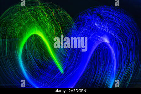 Green and blue light patterns on black background Stock Photo