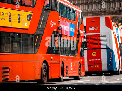 Queue of London Red Double Decker Buses in busy London Street, The first recorded London bus was in 1829 Stock Photo