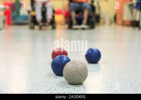 Disabled Boccia players training on a wheelchair. Close up of