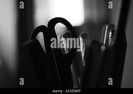 stationery scissors and a set of pencils in a stand, bw photo Stock Photo