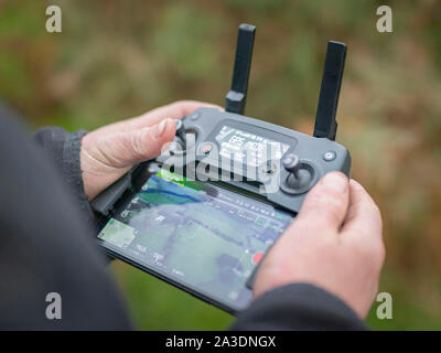 DJI Mavic Pro Platinum Drone controller using iPhone interface young man hobby Stock Photo