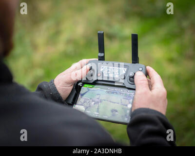 DJI Mavic Pro Platinum Drone controller using iPhone interface young man hobby Stock Photo