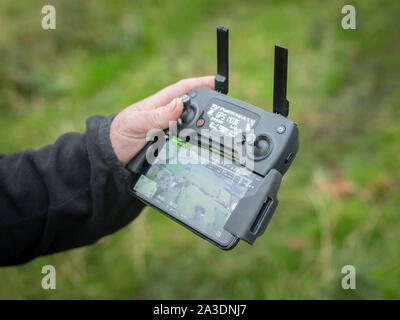DJI Mavic Pro Platinum Drone controller using iPhone interface young man hobby Stock Photo