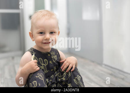 Surprised Little Baby on Floor in Home Interior Stock Photo
