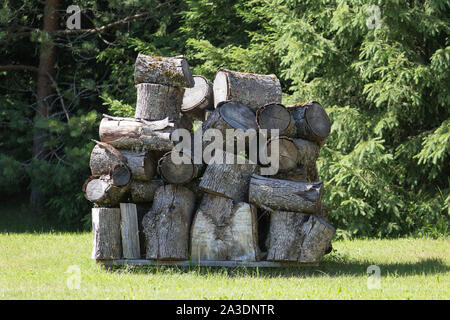 Stacks of Firewood. Wall firewood, background of dry chopped firewood in a pile. Stock Photo