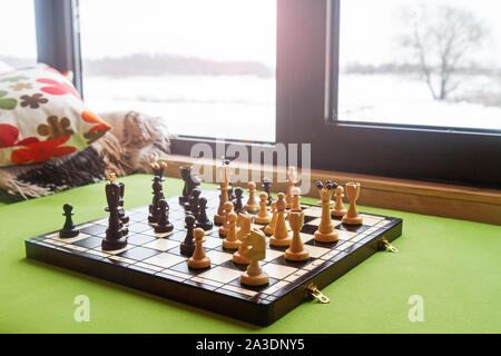 chess stand on a windowsill in a winter day Stock Photo