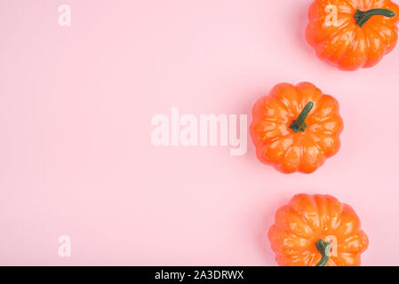 Pink background with three pumpkins. Stock Photo
