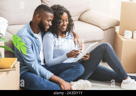 Happy couple using digital tablet for online shopping Stock Photo