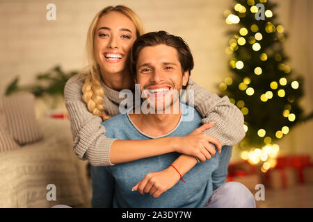 Happy couple looking at camera on new year's eve Stock Photo