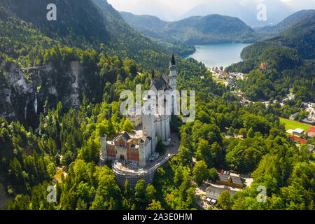 Aerial view on Neuschwanstein Castle Schwangau, Bavaria, Germany. Drone picture on Alpsee lake in Alps mountains Stock Photo