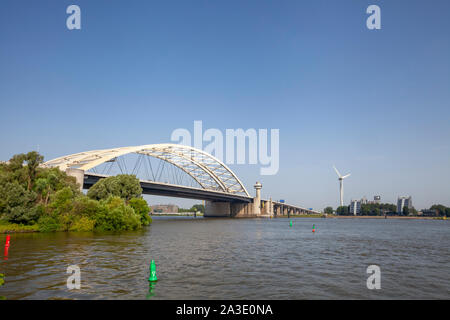 Van Brienenoord Bridge in Rotterdam over the river Nieuwe Maas seen from the north bank on the east side. The two arch bridges, part of the A16 motorw Stock Photo