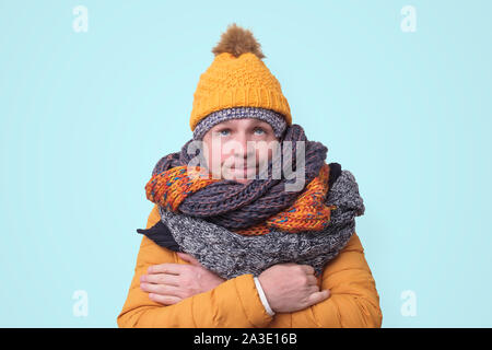 Handsome caucasian funny man in several hats and scarfs. Stock Photo