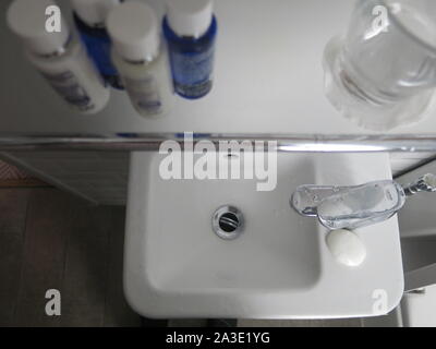 Impractical bathroom layouts and single use plastics are common consumer complaints for the big chain hotels; this washbasin was tiny & awkward to use. Stock Photo