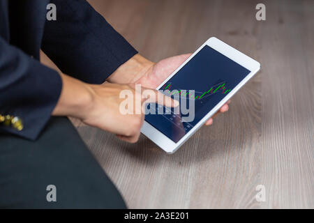 Stock Trader Looking At Stock Chart on Screen Stock Photo