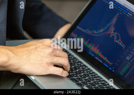 Stock Trader Looking At Stock Chart on Screen Stock Photo