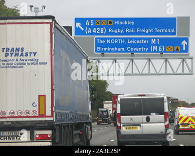 Overhead gantry signs travelling north on the M1 indicating the upcoming junction to turn off for the A5 towards Hinckley and A428 to Rugby. Stock Photo