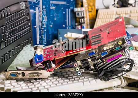E-waste dump pile. Discarded computer parts. Waste sorting and disposal of electronic components. Plastic keyboards, cards, circuit boards, heatsinks. Stock Photo